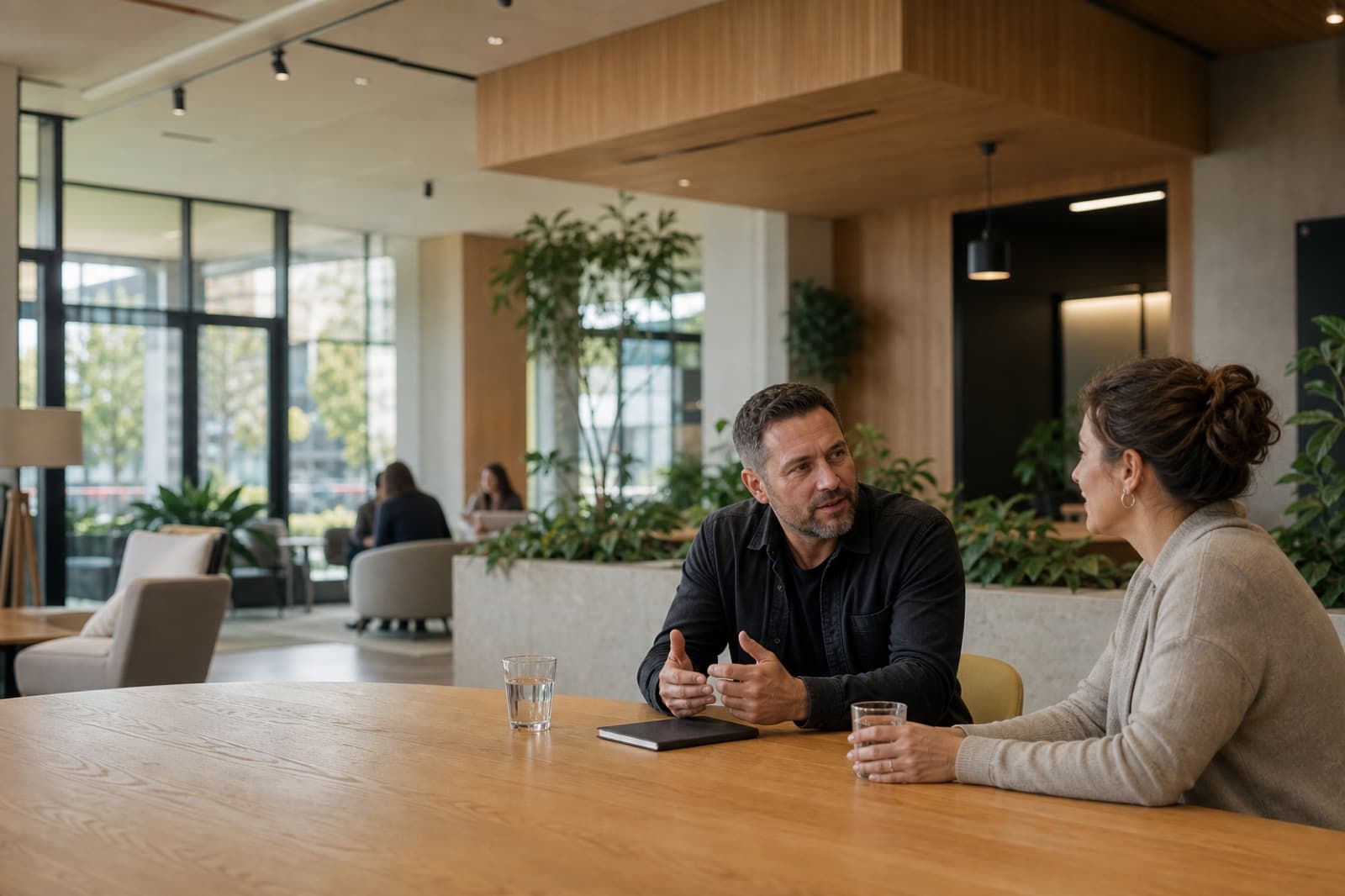Two people discussing a building experience in a shared workplace
